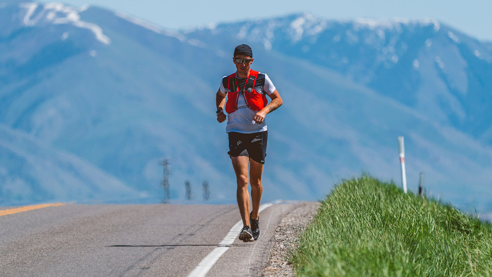 Ultra Runner Michael McKnight crests hill with Bear River mountain range in background