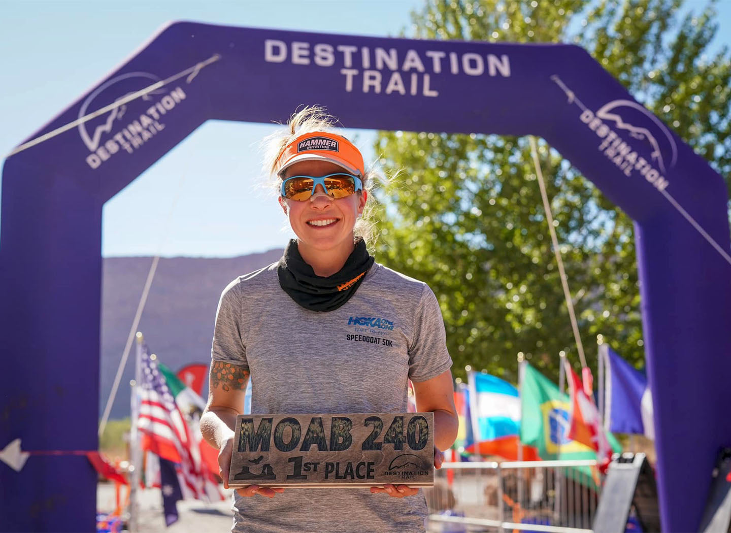 Jesse Morton-Langehaug holding first-place trophy at Moab 240 finish line