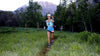 Trail runner running across field at Squaw Peak - Susie Kramer